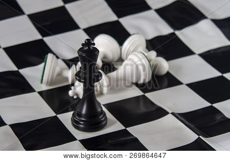 Black Chess King Standing On Chessboard, White King Fallen With Pawns. Strategy, Finance, Business C