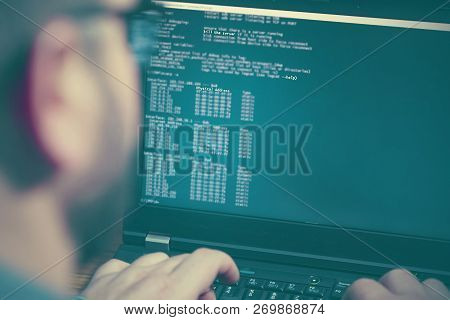 Hacker In Glasses Breaking Code. Criminal Hacker Penetrating Network System From His Dark Hacker Roo