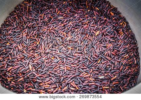 Thai Black Jasmine Rice / Riceberry Organic Food / Pile Of Raw Riceberries On Wood Background Produc