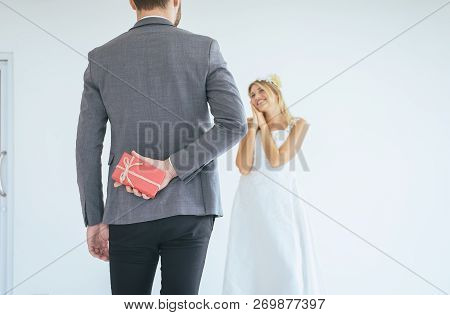 Groom Hiding Red Gift Box Behind Back In Order To Surprise Bride On The Wedding Day,woman Positive E