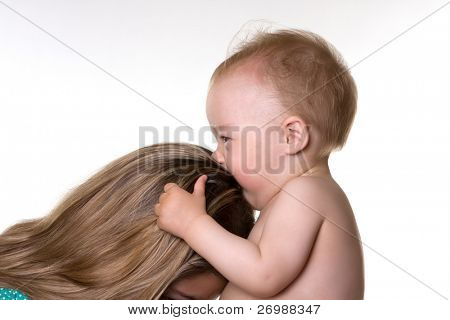 Baby kisses his mother in her hair