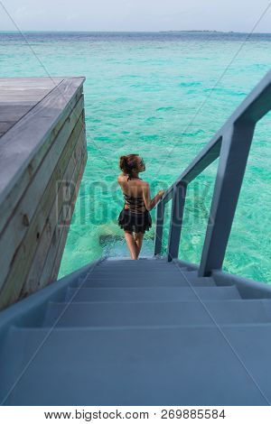 Asian Sexy Woman In Black Bikini At Overwater Villa In Luxury Resport, Vacation Holidays Concepts Ba