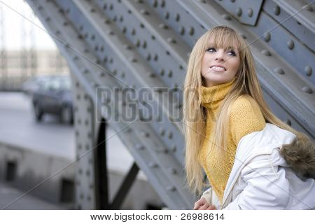 The image of a girl who walks on the background of the city