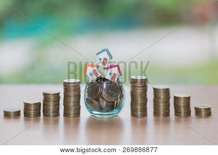Mini House On Stack Of Coins,money And House,  Mortgage, Savings Money For Buy House And Loan To Bus