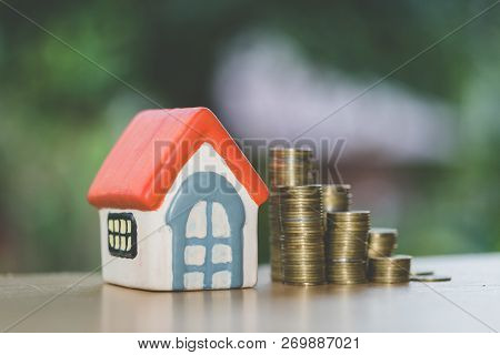 Mini House On Stack Of Coins,money And House,  Mortgage, Savings Money For Buy House And Loan To Bus