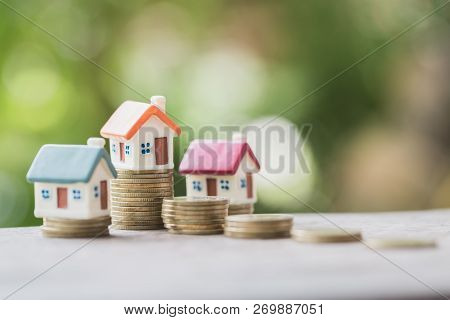 Mini House On Stack Of Coins,money And House,  Mortgage, Savings Money For Buy House And Loan To Bus
