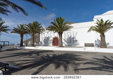 White Church And Palm Trees In Femes In Lanzarote. Canary Islands. Spain