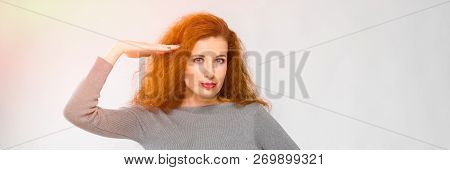 Charming Young Girl With Red Hair. A Young Girl In A Gray Sweater. Young Girl On A Gray Background. 