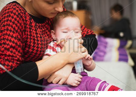 Mom Makes Inhalation Of The Child, Holding Hands