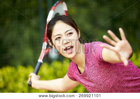 Young Asian Woman Female Tennis Player Hitting Ball With Forehand