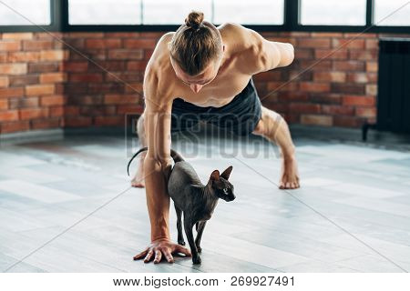 Pet Yoga. Training With Your Animals Can Be Fun. Fit Healthy Strong Yogi Trying Exercise With His Sp