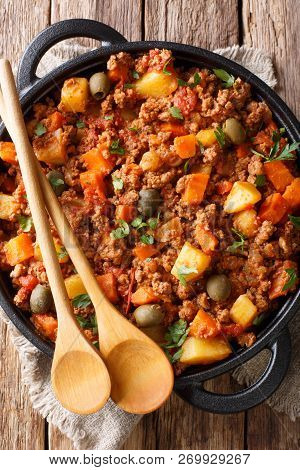 Picadillo Recipe ground Beef, Carrot And Potatoes Cooked In A Tomato Sauce Closeup On A Pan. Vertica