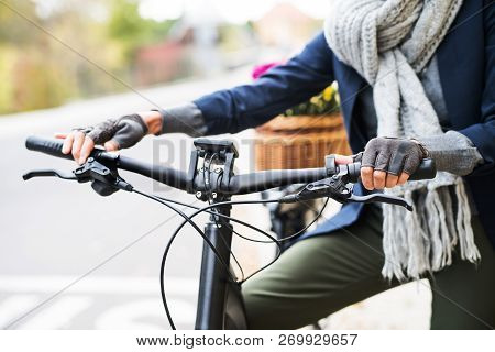 A Midsection Of Senior Woman With Electrobike Outdoors In Town.