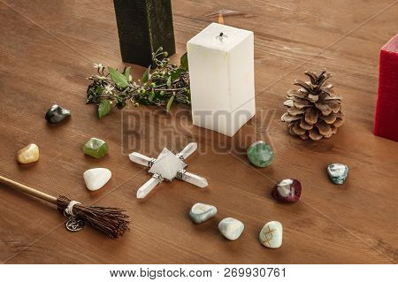 Witchcraft. A Photo Of A Wicca Altar With Candles, Crystal Stones, And Norse Runes, With A Little Br