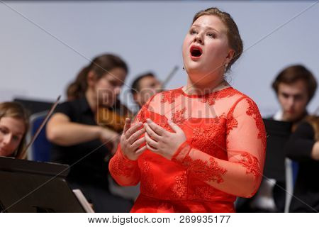 ST. PETERSBURG, RUSSIA - NOVEMBER 17, 2018: Unidentified female singer accompanied by symphony orchestra of Leningrad region perform during Saint-Petersburg International Cultural Forum