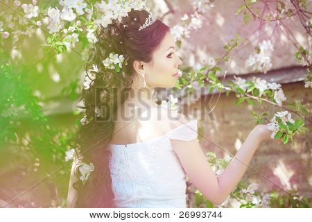 The image of a beautiful bride in a blossoming garden