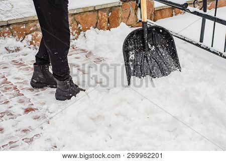 After A Snowfall, A Man Clears Snow From The Road In Winter, Work In The Winter Season.