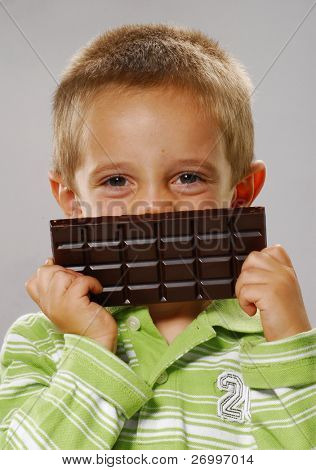 Little boy holding chocolate bar,Little boy eating chocolate,