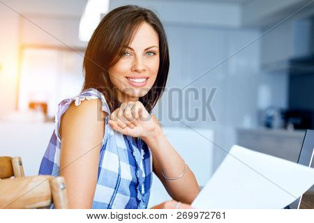 Woman with papers in their living room