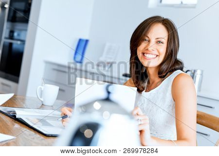 Woman with papers in their living room