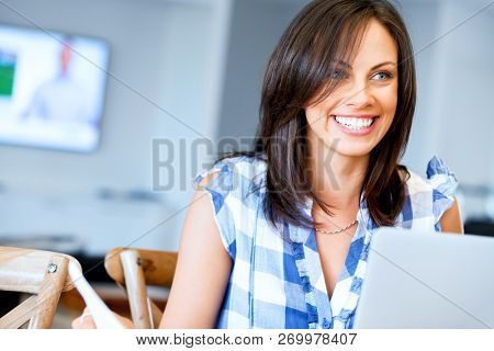 Woman with papers in their living room