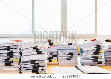Pile Of Unfinished Documents On Office Desk.