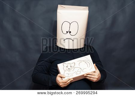 The Concept Of Emotions. The Man Is Holding A Small Kitten. The Face Expresses Surprise And Affectio