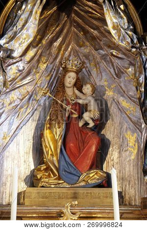 WURZBURG, GERMANY - JULY O4, 2018: Madonna with child Jesus, altar in the Neumunster Collegiate Church in Wurzburg, Germany