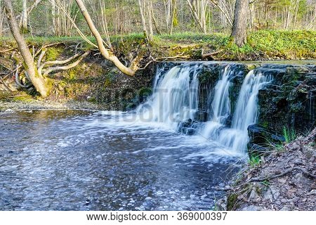 Beautiful View In Spring Of A Waterfall In A Small River