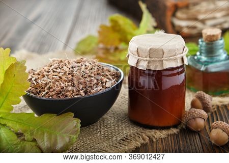 Healthy Oak Bark In Black Ceramic Bowl, Jar Of Herbal Salve Or Balm, Infusion Or Tincture Bottle, Ol