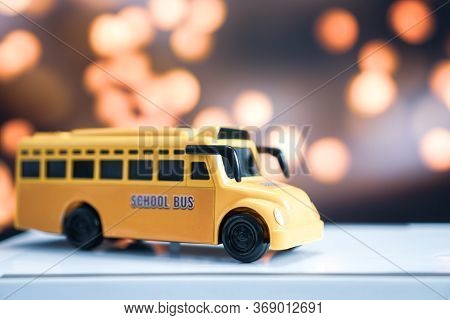 Yellow School Mini Bus Kids Toy, Student Transport For Children Transports Service On Blurred Agains