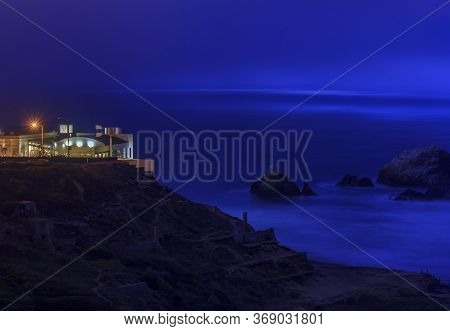 Ruins Of The Sutro Baths At Lands End On Ocean Beach, The Cliff House In The Background In San Franc