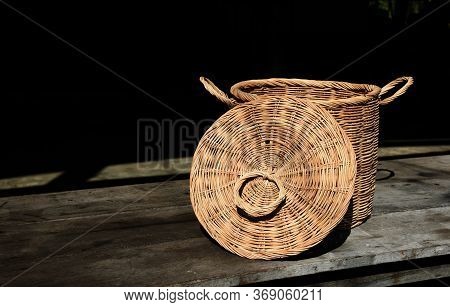 Rattan Wicker Basket On Old Wood Table Isolate Black Background , Handmade