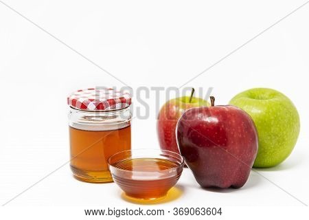 Rosh Hashanah (jewish New Year) Traditional Symbols, Honey In A Glass Jar, Red And Green Apples. Iso