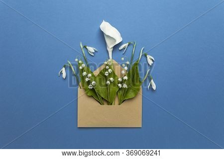 Spring Flowers In A Mail Envelope On A Blue Background. Romantic Birthday Greetings, Creative Weddin