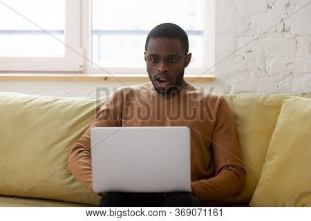 African Ethnicity Guy Gawp At Laptop Screen Feels Shocked