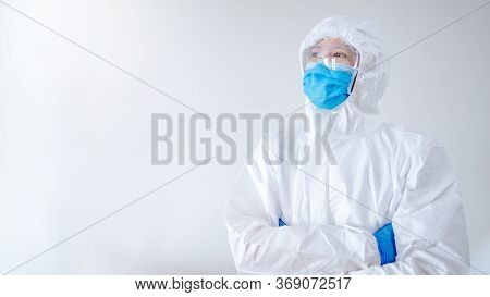 Doctor Or Physician In Personal Protective Equipment Standing With Arms Crossed Posing In Hospital C