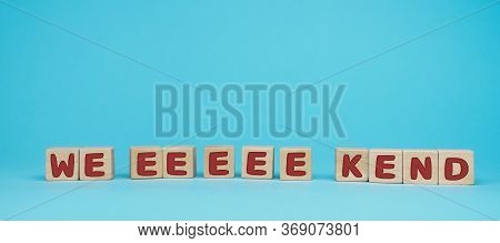 Word Weekend Written On Wood Block. Have A Wonderful Weekend Text On Blue Background