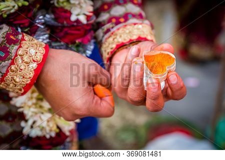 The Groom's Hand Holding Sindur Or Vermilion Before Applying On The Bride`s Hair-parting.selective F
