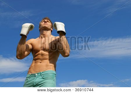 Strong Man In Boxing Gloves. The Winner.