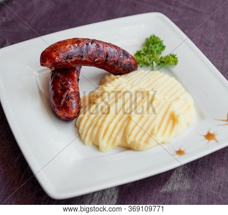 Potatoe With Sousages On The White Plate