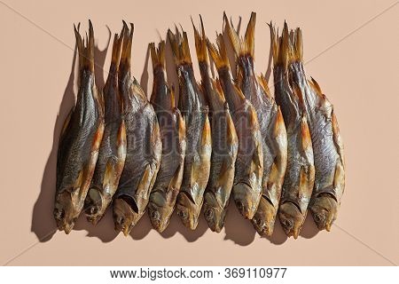 Lots Of Dried Or Jerky Salty Roach, Palatable Clipfish On Pink Background. Famous Beer Snack. Tradit