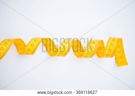 Yellow Easuring Tape On The White Background With The Copy Space