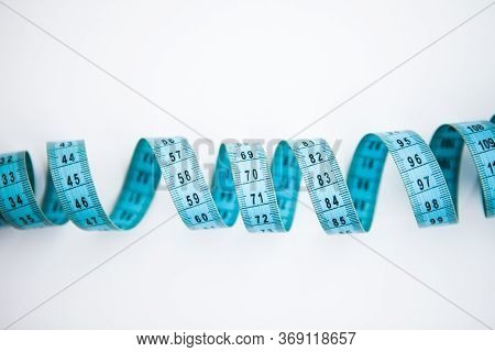 Blue Easuring Tape On The White Background With The Copy Space