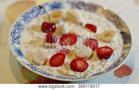 Healthy Breakfast - Porridge With Fruit Strawberry, Banana And Cherry