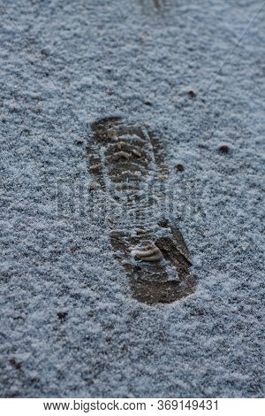 Human Single Footprint In White Fresh Winter Snow. Top View. Simple Trace Of Boot In Fallen Snow. Sh