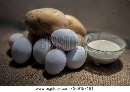 Potato And Egg White Face Mask To Achieve Natural Glowing Skin On A Brown Colored Surface With Raw P