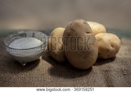 Potato And Egg White Face Mask To Achieve Natural Glowing Skin On A Brown Colored Surface With Raw P