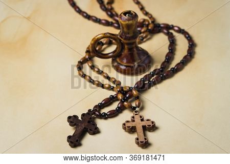 Religion Concept. Christian Religion. Two Wooden Crosses On Wooden Chains. Between The Crosses Is A 