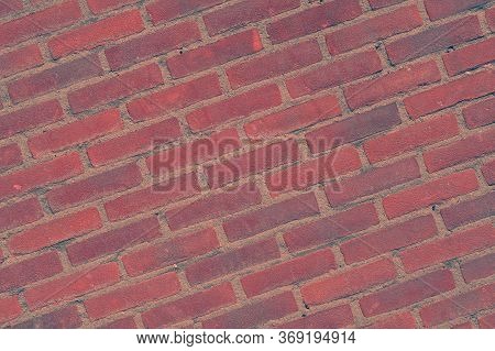 Photo Of A Sloping Red Brick Wall. Red Stone Wall, Background, Texture. Old Red Brick Wall Texture B